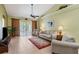 Comfortable living room featuring a ceiling fan, rug, neutral paint and lots of natural light at 1567 Monarch Dr, Venice, FL 34293