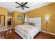 This is the main bedroom with a king bed that includes a ceiling fan and hardwood floors at 1567 Monarch Dr, Venice, FL 34293