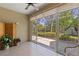 Enclosed patio features tile floors, ceiling fan and beautiful views of the yard and mature landscaping at 1567 Monarch Dr, Venice, FL 34293