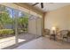 Enclosed patio features tile floors, neutral paint and beautiful views of the lush landscaping at 1567 Monarch Dr, Venice, FL 34293