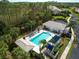 Community pool and lounge with pool chairs and covered picnic area surrounded by mature landscaping at 1567 Monarch Dr, Venice, FL 34293