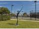 View of the community tennis courts featuring a statue of tennis player and well maintained landscaping at 1567 Monarch Dr, Venice, FL 34293