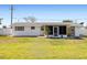 View of the home's backyard with a manicured lawn and fenced perimeter at 1600 Maryknoll Rd, Englewood, FL 34223