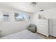 Light and airy bedroom with a neutral color palette and an accent chair at 1600 Maryknoll Rd, Englewood, FL 34223