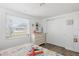 Bedroom with laminate flooring, white walls, closet with sliding doors, and window at 1600 Maryknoll Rd, Englewood, FL 34223