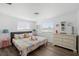 Bright bedroom with decorative bed, light walls, and two windows overlooking the yard at 1600 Maryknoll Rd, Englewood, FL 34223
