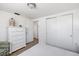 Light and airy bedroom featuring wood floors, dresser, and closet at 1600 Maryknoll Rd, Englewood, FL 34223