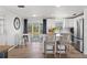 Modern kitchen with stainless steel appliances, bar seating, and ample natural light at 1600 Maryknoll Rd, Englewood, FL 34223