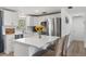Bright kitchen features white cabinets, stainless steel appliances, breakfast bar, and quartz countertops at 1600 Maryknoll Rd, Englewood, FL 34223
