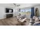 Cozy living room with stylish furniture, fireplace, and ample natural light at 1600 Maryknoll Rd, Englewood, FL 34223
