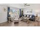 Comfortable living room featuring a stylish couch, accent chair, and coastal decor at 1600 Maryknoll Rd, Englewood, FL 34223