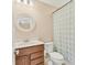 Bathroom with a decorative mirror, wood vanity, and shower/tub combo with a patterned curtain at 16258 Hidden Oak Loop, Bradenton, FL 34211