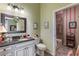 Bathroom with granite countertop, decorative wallpaper, and walk-in shower at 1627 Lancashire Dr, Venice, FL 34293