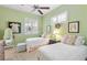 Bright bedroom with twin beds, ceiling fan and shuttered window at 1627 Lancashire Dr, Venice, FL 34293