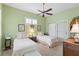 Light-filled bedroom with twin beds, ceiling fan and shuttered window at 1627 Lancashire Dr, Venice, FL 34293