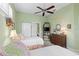 Bright bedroom featuring twin beds, a ceiling fan and dresser at 1627 Lancashire Dr, Venice, FL 34293