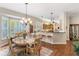 Bright dining area with wood floors, breakfast bar, and a large window for natural light at 1627 Lancashire Dr, Venice, FL 34293