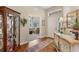 Inviting entryway with hardwood floors, decorative console table, and doorway to living area at 1627 Lancashire Dr, Venice, FL 34293