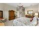 The main bedroom offers a ceiling fan, area rug and an armoire at 1627 Lancashire Dr, Venice, FL 34293