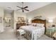 Bright main bedroom featuring a ceiling fan and neutral carpeting at 1627 Lancashire Dr, Venice, FL 34293