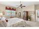 Bright bedroom with a ceiling fan, area rug and armoire at 1627 Lancashire Dr, Venice, FL 34293