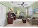 Comfortable office space featuring neutral carpet, a ceiling fan, and a desk setup at 1627 Lancashire Dr, Venice, FL 34293