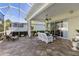 Inviting patio showcasing brick pavers, covered seating, and outdoor decor at 1627 Lancashire Dr, Venice, FL 34293