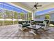 Outdoor patio featuring screened in enclosure, comfortable seating and scenic views at 1627 Lancashire Dr, Venice, FL 34293