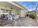 Covered patio with tiled flooring, ceiling fan, and comfortable seating area at 1627 Lancashire Dr, Venice, FL 34293