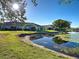 Beautiful backyard features pond and lake view, surrounded by community landscaping at 1808 San Silvestro Dr, Venice, FL 34285