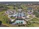 Birds eye view of community clubhouse with inviting pool, golf course, and parking at 1853 San Silvestro Dr, Venice, FL 34285