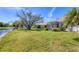 Spacious backyard with a view of the pond, featuring a screened lanai at 1853 San Silvestro Dr, Venice, FL 34285