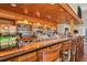 Fully stocked bar and barstool seating offers a warm and inviting atmosphere for dining and socializing at 1853 San Silvestro Dr, Venice, FL 34285