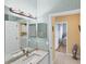 This bathroom features a decorative light fixture, granite vanity, and access to the laundry room at 1853 San Silvestro Dr, Venice, FL 34285
