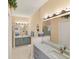 Elegant bathroom with dual vanities, granite countertops, and walk-in shower at 1853 San Silvestro Dr, Venice, FL 34285