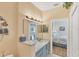 Elegant bathroom vanity with granite countertop and a view to the bedroom at 1853 San Silvestro Dr, Venice, FL 34285