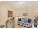 Comfortable bedroom with a sofa and dresser, offering a tranquil and relaxing space at 1853 San Silvestro Dr, Venice, FL 34285