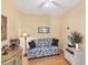 Comfortable bedroom with a sofa and dresser, offering a tranquil and relaxing space at 1853 San Silvestro Dr, Venice, FL 34285