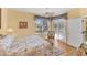 Bright bedroom featuring a ceiling fan, wicker furniture, and access to a screened-in patio at 1853 San Silvestro Dr, Venice, FL 34285