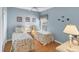 Cozy bedroom with two twin beds, nautical decor and light wood floors at 1853 San Silvestro Dr, Venice, FL 34285