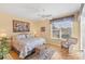 Bright bedroom featuring a ceiling fan, wicker furniture, and a lovely window view of the outside scenery at 1853 San Silvestro Dr, Venice, FL 34285