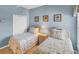 Charming bedroom featuring two twin beds, and light-blue walls with themed artwork at 1853 San Silvestro Dr, Venice, FL 34285