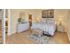 Well-lit bedroom with charming nautical decor, light wood floors, and a view into the en-suite bathroom at 1853 San Silvestro Dr, Venice, FL 34285