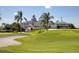 Golf clubhouse with lush green lawn and landscaping at 1853 San Silvestro Dr, Venice, FL 34285
