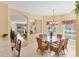 Dining room with window and view to living room and sliding glass doors at 1853 San Silvestro Dr, Venice, FL 34285