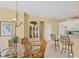 Dining room with seating, chandelier, and view to kitchen at 1853 San Silvestro Dr, Venice, FL 34285