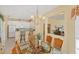 Dining room with chandelier overlooking the kitchen and bar seating at 1853 San Silvestro Dr, Venice, FL 34285