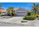 An attractive exterior view displaying the tile roof, garage and well-manicured landscaping surrounding the home at 1853 San Silvestro Dr, Venice, FL 34285