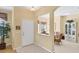 Inviting foyer with tile floors, decorative plant, and view of dining and kitchen areas at 1853 San Silvestro Dr, Venice, FL 34285