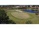 Scenic golf course view showcasing lush greens, a pristine pond, and manicured landscaping enhancing the golfing experience at 1853 San Silvestro Dr, Venice, FL 34285